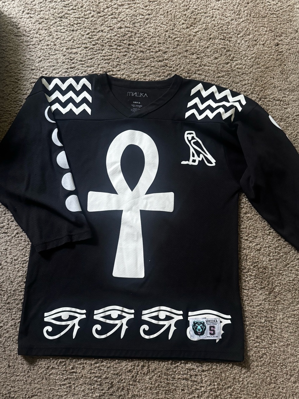 Mishka Black Hockey-Style Jersey with White Ankh & Eye Motifs